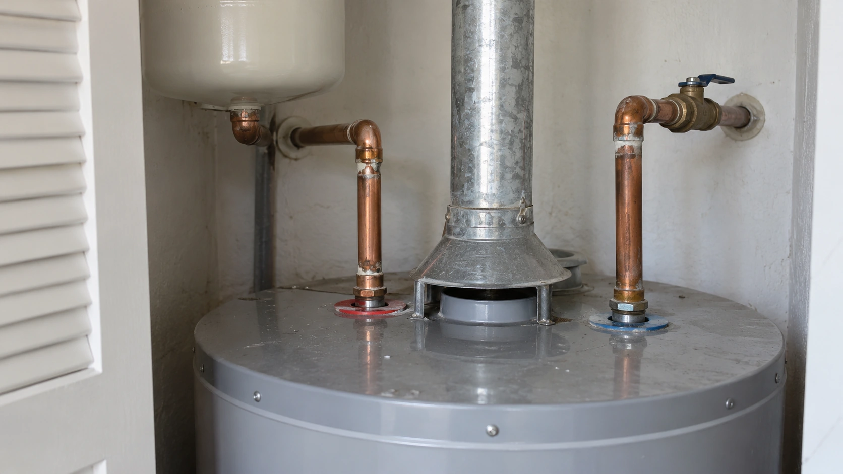 The top of a water heater in a utility closet.